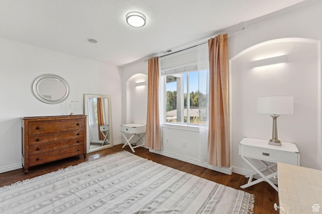 1044 S Terrace Dr E, Bountiful, UT 84010 - bedroom featuring arched walkways and dark wood-type flooring