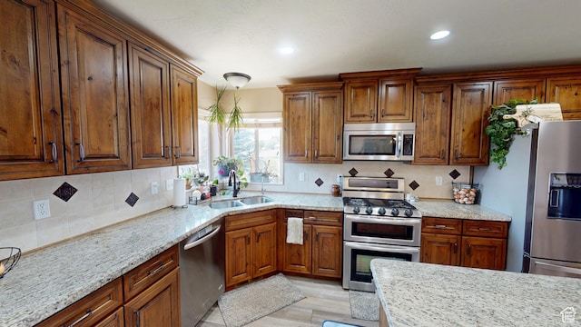 1605 W 1400 S, Vernal, UT 84078 - kitchen with appliances with stainless steel finishes, tasteful backsplash, light stone counters, recessed lighting, and brown cabinetry