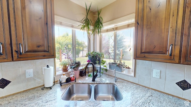 1605 W 1400 S, Vernal, UT 84078 - kitchen featuring light stone counters, backsplash, and vaulted ceiling