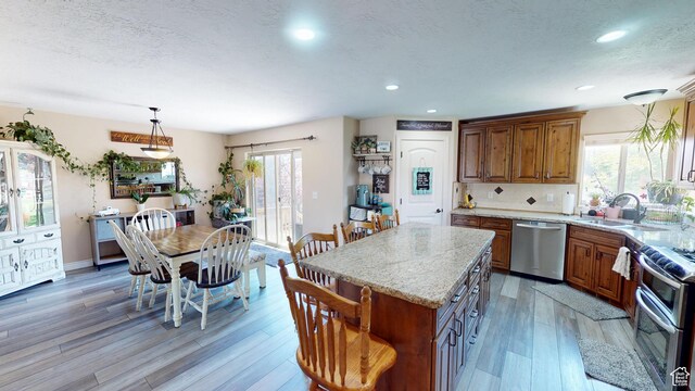 1605 W 1400 S, Vernal, UT 84078 - kitchen with appliances with stainless steel finishes, brown cabinets, light stone countertops, light wood-style flooring, and recessed lighting
