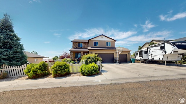 1605 W 1400 S, Vernal, UT 84078 - view of front of house with stone siding, an attached garage, driveway, stucco siding, and a garage