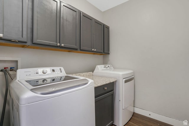 13054 S Tortola Dr W Unit 301, Herriman, UT 84096 - washroom with washer and dryer, cabinet space, and dark wood-style floors