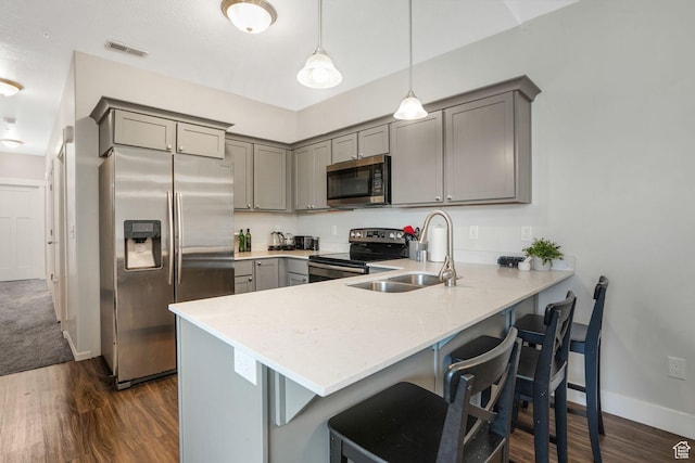 13054 S Tortola Dr W Unit 301, Herriman, UT 84096 - kitchen featuring gray cabinetry, stainless steel appliances, a peninsula, and dark wood-style floors