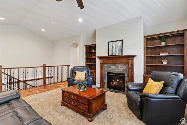 2681 E Sunshine Ct S, South Weber, UT 84405 - living room featuring a ceiling fan, arched walkways, recessed lighting, a tile fireplace, and lofted ceiling