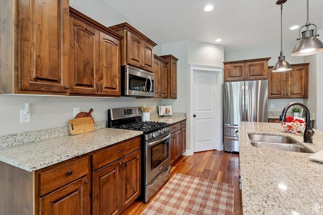 2681 E Sunshine Ct S, South Weber, UT 84405 - kitchen featuring stainless steel appliances, light stone countertops, dark wood finished floors, hanging light fixtures, and recessed lighting