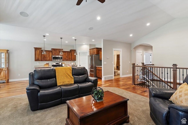 2681 E Sunshine Ct S, South Weber, UT 84405 - living room featuring a ceiling fan, light wood-type flooring, arched walkways, vaulted ceiling, and recessed lighting