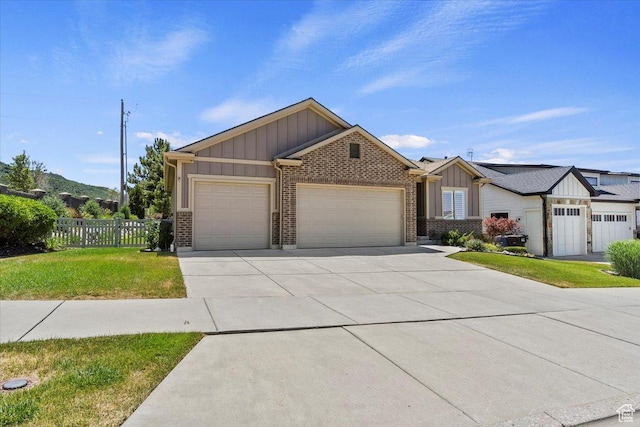 2681 E Sunshine Ct S, South Weber, UT 84405 - view of front of home featuring board and batten siding, an attached garage, brick siding, and concrete driveway