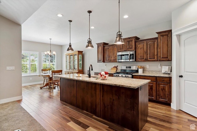 2681 E Sunshine Ct S, South Weber, UT 84405 - kitchen featuring appliances with stainless steel finishes, wood finished floors, a kitchen island with sink, recessed lighting, and decorative light fixtures
