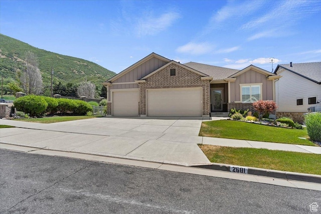 2681 E Sunshine Ct S, South Weber, UT 84405 - view of front of property with board and batten siding, an attached garage, brick siding, and concrete driveway