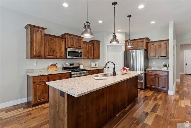 2681 E Sunshine Ct S, South Weber, UT 84405 - kitchen featuring appliances with stainless steel finishes, arched walkways, dark wood-style floors, recessed lighting, and a center island with sink