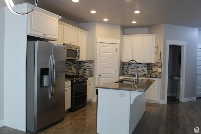 4442 W Hill Shadow Way S, Herriman, UT 84096 - kitchen with appliances with stainless steel finishes, recessed lighting, dark wood finished floors, white cabinetry, and backsplash
