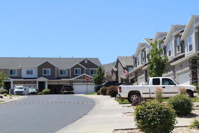 4442 W Hill Shadow Way S, Herriman, UT 84096 - view of asphalt road with a residential view, traffic signs, sidewalks, and curbs