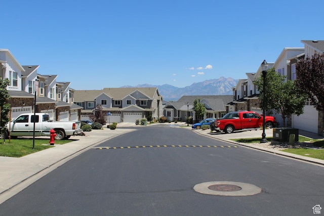 4442 W Hill Shadow Way S, Herriman, UT 84096 - view of asphalt street featuring a residential view, curbs, a mountain view, sidewalks, and street lighting