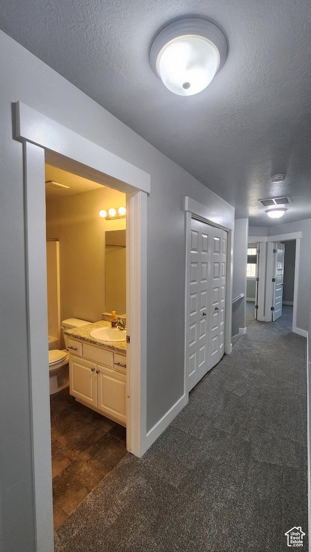 4442 W Hill Shadow Way S, Herriman, UT 84096 - corridor with a textured ceiling and dark carpet