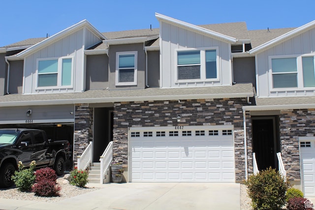 4442 W Hill Shadow Way S, Herriman, UT 84096 - townhome / multi-family property featuring board and batten siding, a garage, stone siding, concrete driveway, and a shingled roof