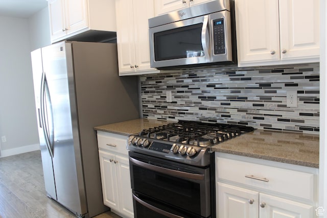 4442 W Hill Shadow Way S, Herriman, UT 84096 - kitchen with stainless steel appliances, light wood finished floors, and white cabinets