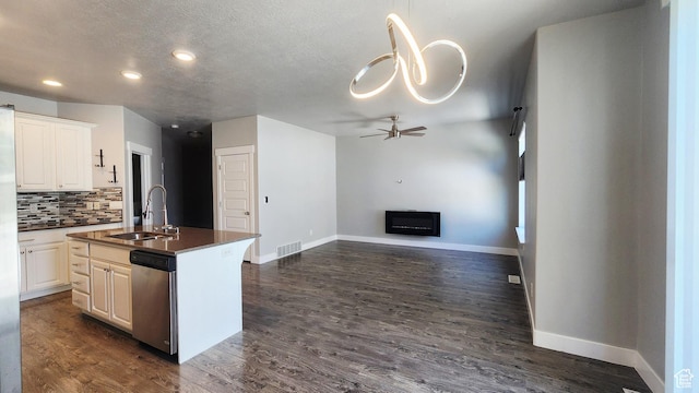 4442 W Hill Shadow Way S, Herriman, UT 84096 - kitchen featuring stainless steel dishwasher, a ceiling fan, dark countertops, open floor plan, and backsplash