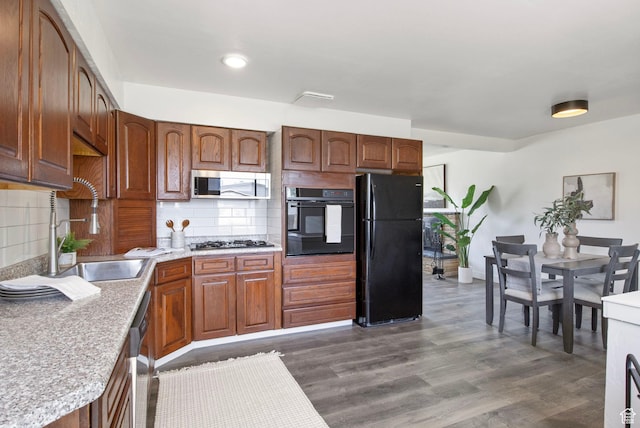 1908 W Champagne Ave, Taylorsville, UT 84129 - kitchen featuring black appliances, light countertops, tasteful backsplash, dark wood-style floors, and recessed lighting