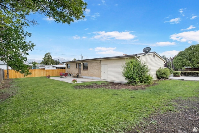 1908 W Champagne Ave, Taylorsville, UT 84129 - back of property with a patio and brick siding