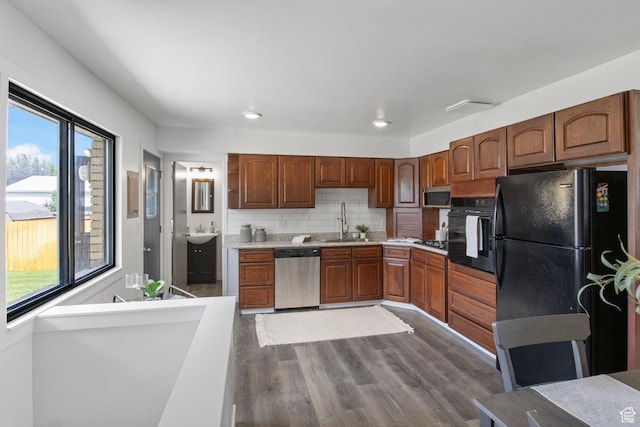 1908 W Champagne Ave, Taylorsville, UT 84129 - kitchen with black appliances, plenty of natural light, dark wood-style floors, tasteful backsplash, and recessed lighting