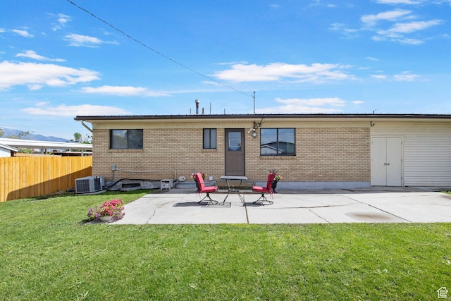 1908 W Champagne Ave, Taylorsville, UT 84129 - back of house with brick siding and a patio area