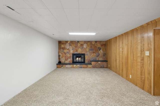 1908 W Champagne Ave, Taylorsville, UT 84129 - unfurnished living room featuring carpet flooring, a stone fireplace, and wooden walls