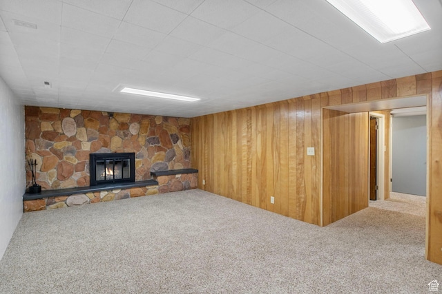 1908 W Champagne Ave, Taylorsville, UT 84129 - unfurnished living room featuring carpet, a stone fireplace, and wooden walls