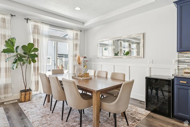 1076 S Meadow Walk Ln, Heber City, UT 84032 - dining room featuring wine cooler, wood finished floors, bar, and a textured ceiling