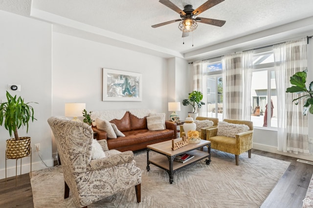1076 S Meadow Walk Ln, Heber City, UT 84032 - living room with wood finished floors, ceiling fan, a textured ceiling, and a tray ceiling