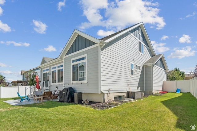 1076 S Meadow Walk Ln, Heber City, UT 84032 - back of house with board and batten siding, a fenced backyard, and a patio