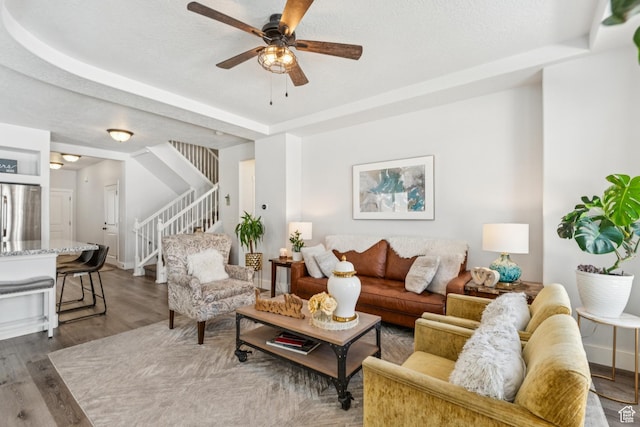 1076 S Meadow Walk Ln, Heber City, UT 84032 - living room with stairway, a ceiling fan, wood finished floors, and a tray ceiling
