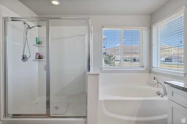 1017 W Coyote Gulch Way S Unit 117, Bluffdale, UT 84065 - bathroom featuring healthy amount of natural light, a garden tub, a shower stall, and recessed lighting