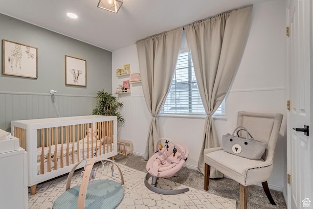 3699 S Botticelli Ct Unit C, Salt Lake City, UT 84119 - bedroom with a nursery area, a wainscoted wall, and carpet