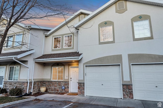 3699 S Botticelli Ct Unit C, Salt Lake City, UT 84119 - townhome / multi-family property with stone siding, stucco siding, and a garage