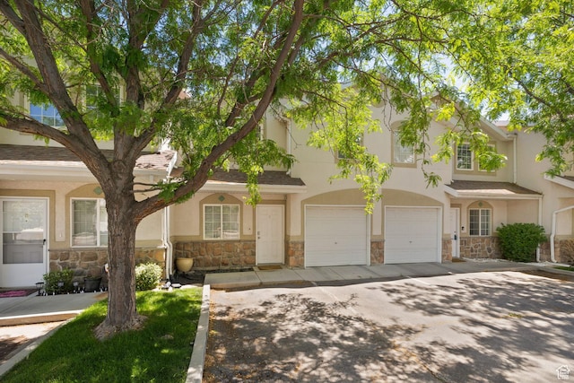 3699 S Botticelli Ct Unit C, Salt Lake City, UT 84119 - multi unit property featuring stone siding, stucco siding, asphalt driveway, and an attached garage