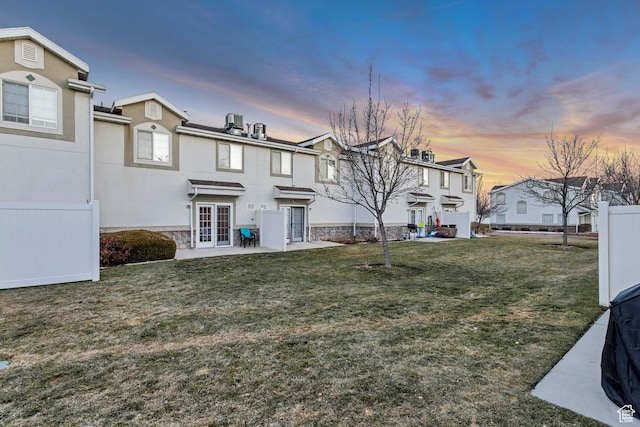 3699 S Botticelli Ct Unit C, Salt Lake City, UT 84119 - view of front of house featuring a residential view, a patio, french doors, stucco siding, and stone siding