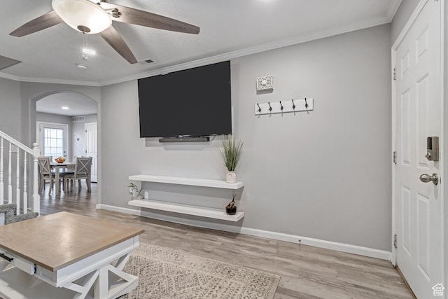 3699 S Botticelli Ct Unit C, Salt Lake City, UT 84119 - living room with arched walkways, light wood-style flooring, ceiling fan, stairway, and ornamental molding
