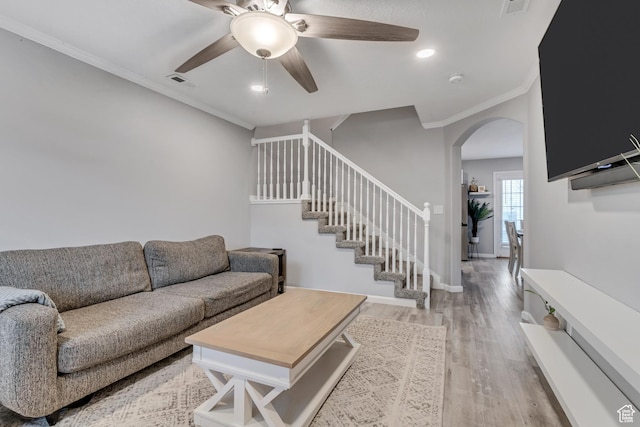 3699 S Botticelli Ct Unit C, Salt Lake City, UT 84119 - living area with crown molding, a ceiling fan, arched walkways, light wood-style floors, and stairs