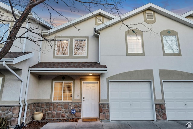 3699 S Botticelli Ct Unit C, Salt Lake City, UT 84119 - multi unit property with stucco siding, an attached garage, stone siding, and driveway