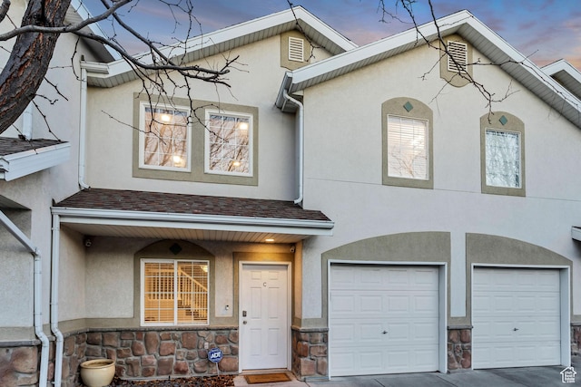 3699 S Botticelli Ct Unit C, Salt Lake City, UT 84119 - multi unit property with stucco siding, a garage, stone siding, and roof with shingles