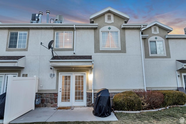 3699 S Botticelli Ct Unit C, Salt Lake City, UT 84119 - back of house at dusk with stucco siding and a patio area