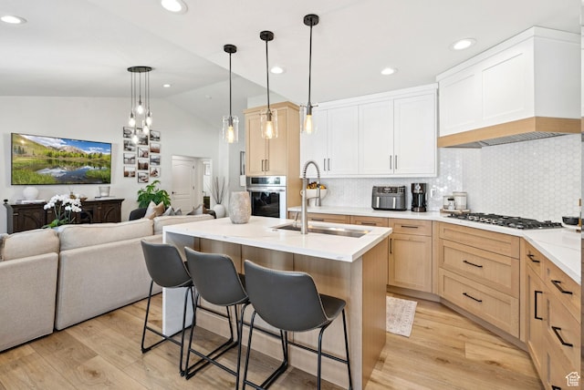 273 N 200 W Unit 1, Kamas, UT 84036 - kitchen featuring stainless steel appliances, open floor plan, vaulted ceiling, light wood-type flooring, and tasteful backsplash