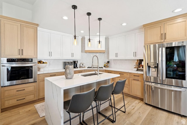 273 N 200 W Unit 1, Kamas, UT 84036 - kitchen with stainless steel appliances, light countertops, backsplash, light brown cabinetry, and recessed lighting