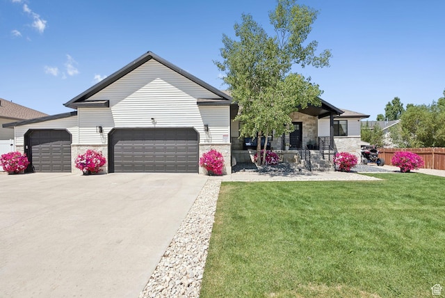 273 N 200 W Unit 1, Kamas, UT 84036 - view of front facade with a garage, concrete driveway, and stone siding