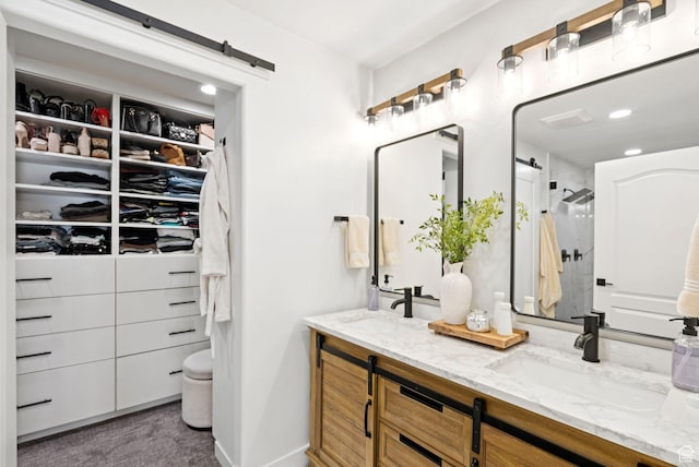 273 N 200 W Unit 1, Kamas, UT 84036 - bathroom featuring double vanity, a shower, a walk in closet, and recessed lighting