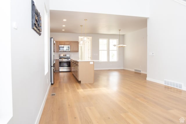 11511 S Pebble Pond Rd, South Jordan, UT 84009 - kitchen with appliances with stainless steel finishes, light countertops, light wood finished floors, recessed lighting, and a chandelier