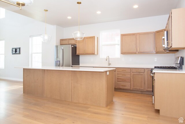 11511 S Pebble Pond Rd, South Jordan, UT 84009 - kitchen with stainless steel appliances, a center island, light wood-style flooring, light countertops, and recessed lighting