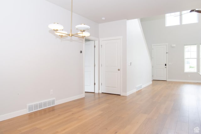 11511 S Pebble Pond Rd, South Jordan, UT 84009 - unfurnished room with a chandelier and light wood-type flooring