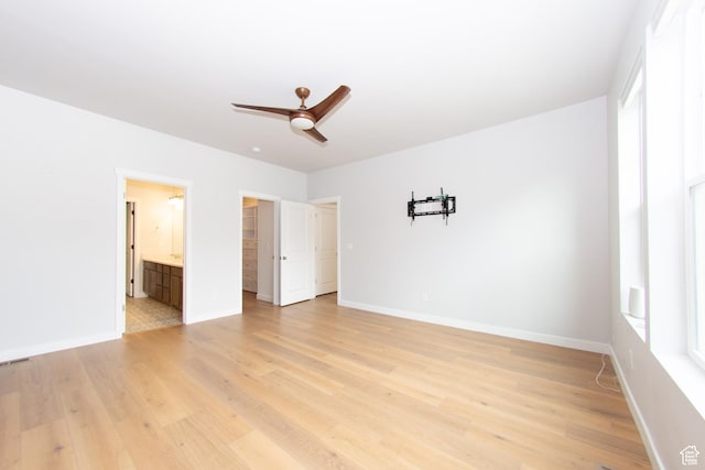 11511 S Pebble Pond Rd, South Jordan, UT 84009 - unfurnished bedroom with light wood-style floors, a spacious closet, ensuite bathroom, and ceiling fan