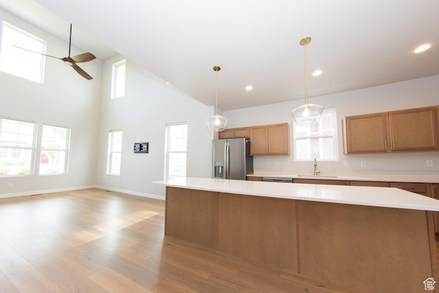 11511 S Pebble Pond Rd, South Jordan, UT 84009 - kitchen featuring stainless steel fridge with ice dispenser, ceiling fan, light countertops, brown cabinetry, and recessed lighting
